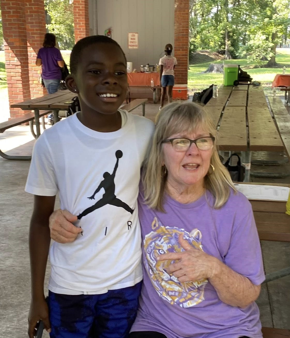 A boy and a woman posing for a photo.